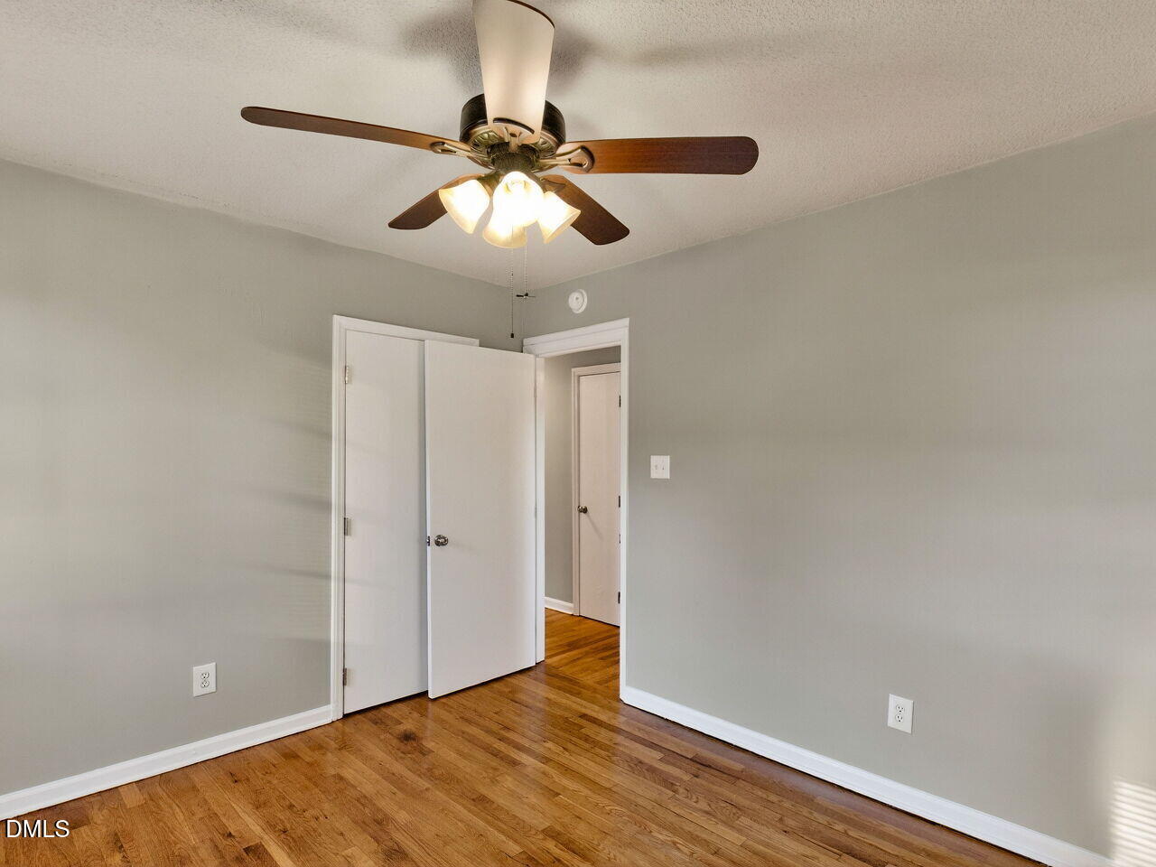 2811 Club Plaza Road Raleigh, NC 27603 - Photo 31 of 38 an empty room with wooden floor closet and fan