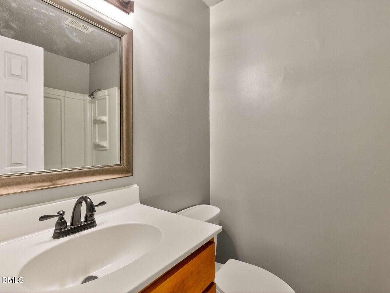 2811 Club Plaza Road Raleigh, NC 27603 - Photo 33 of 38 a bathroom with a sink a toilet and mirror