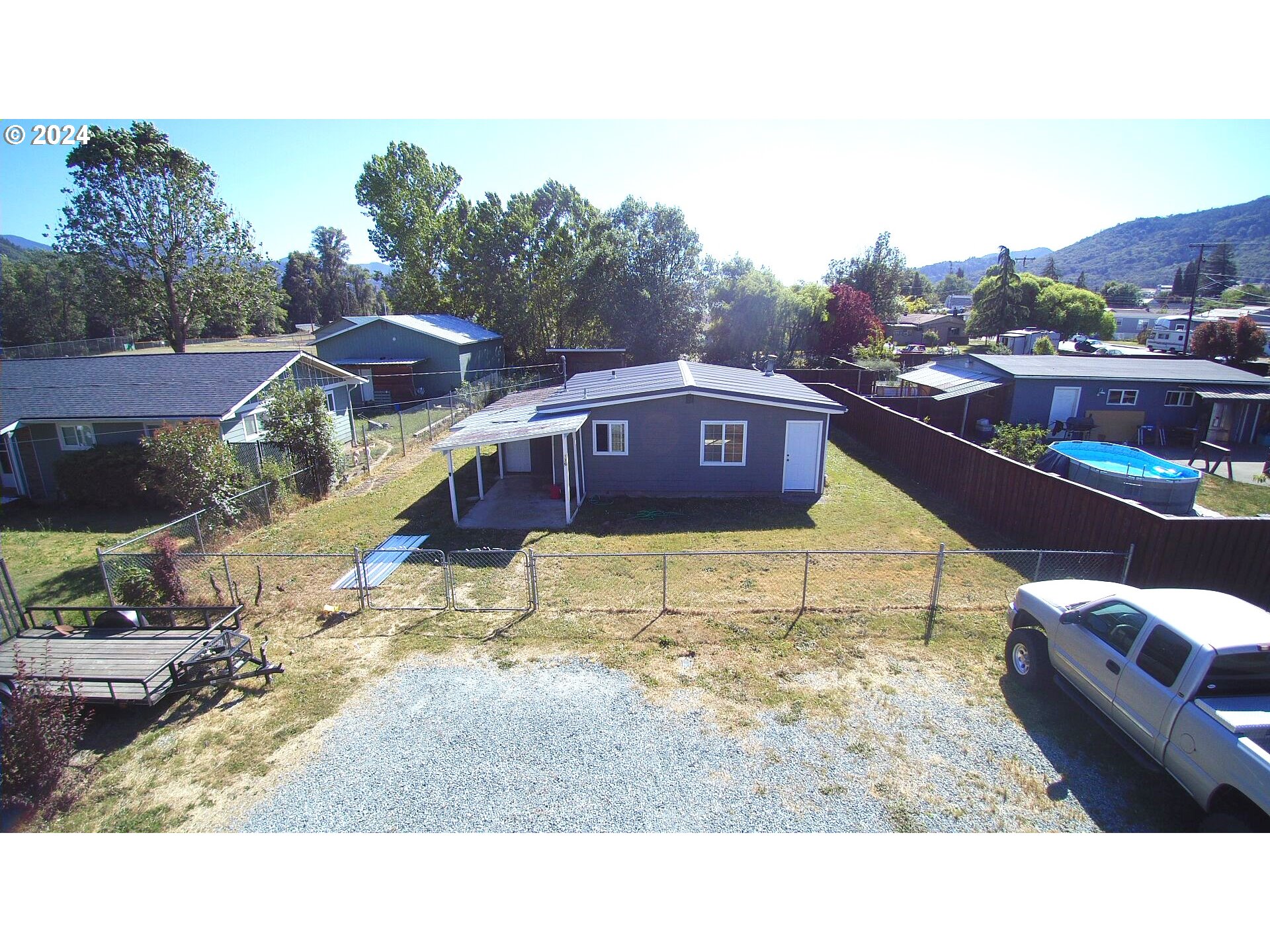 136 Park Street Riddle, OR 97469 - Photo 1 of 17 a balcony with tall trees in the background