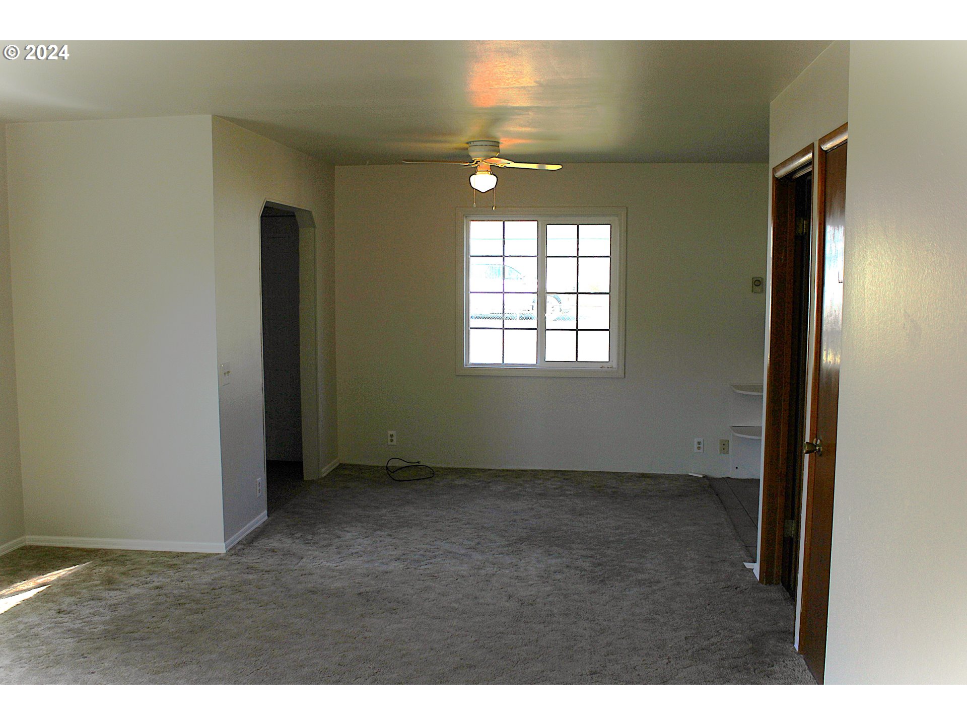 136 Park Street Riddle, OR 97469 - Photo 13 of 17 a view of an empty room with window and wooden floor