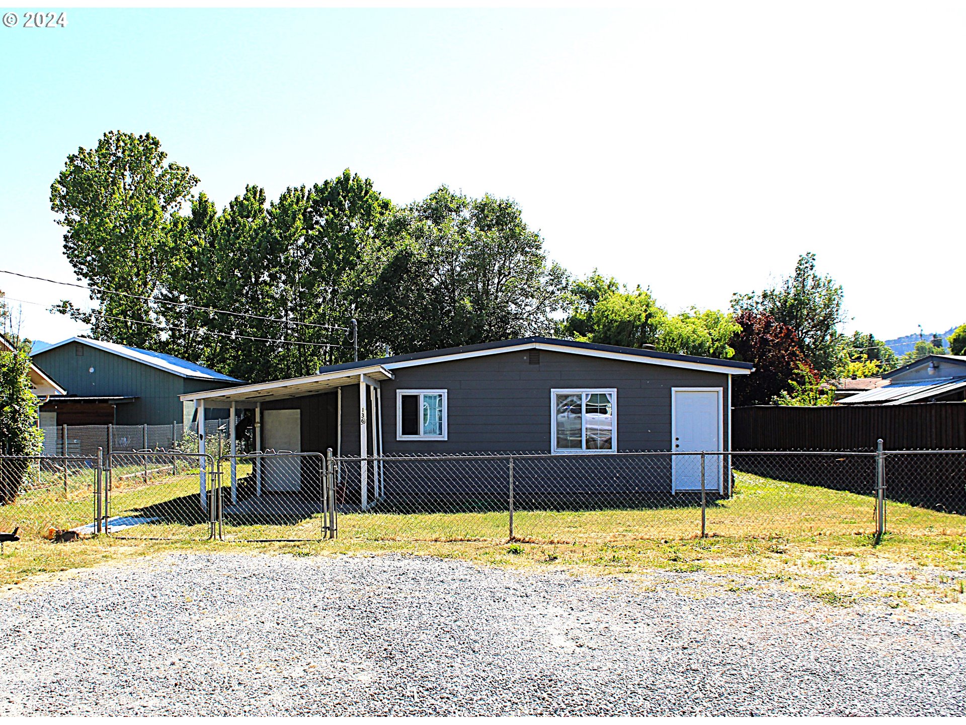 136 Park Street Riddle, OR 97469 - Photo 2 of 17 a view of a house with a swimming pool