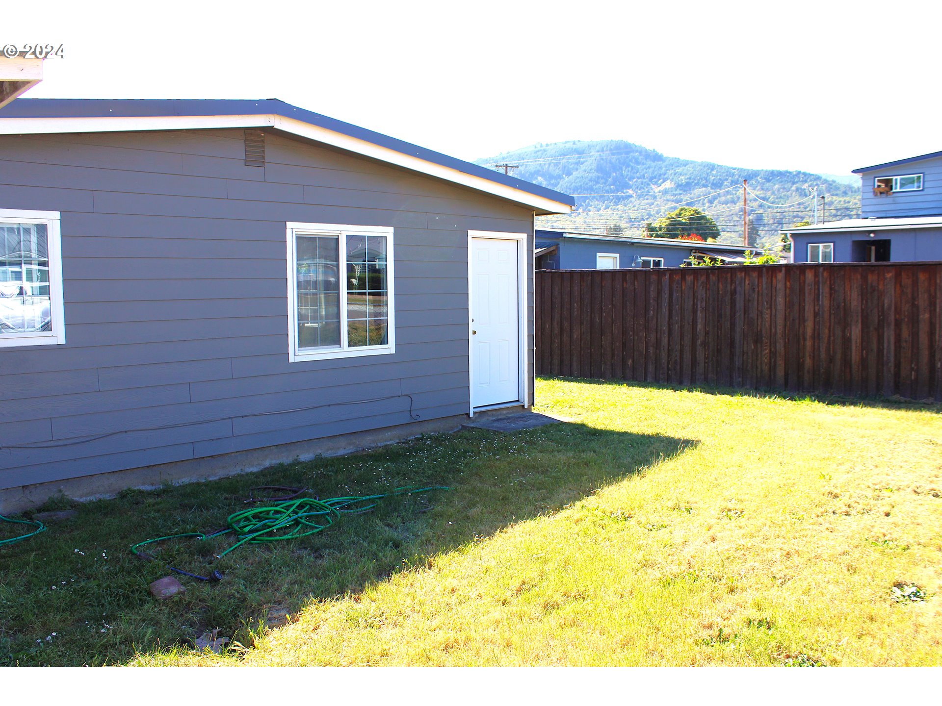 136 Park Street Riddle, OR 97469 - Photo 3 of 17 a view of a backyard with a house