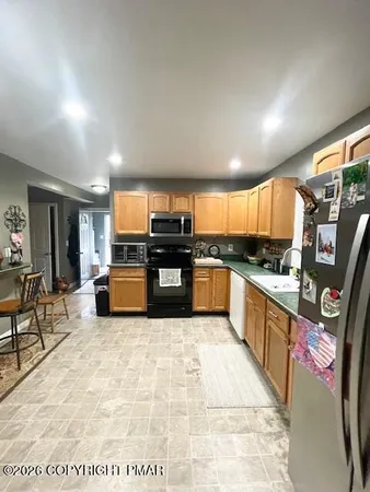 a bathroom with a granite countertop sink a toilet and a mirror