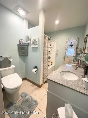 a bathroom with a bathtub sink mirror vanity and toilet