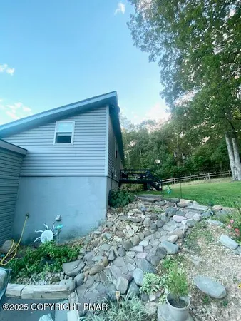 a front view of a house with a yard and a garden