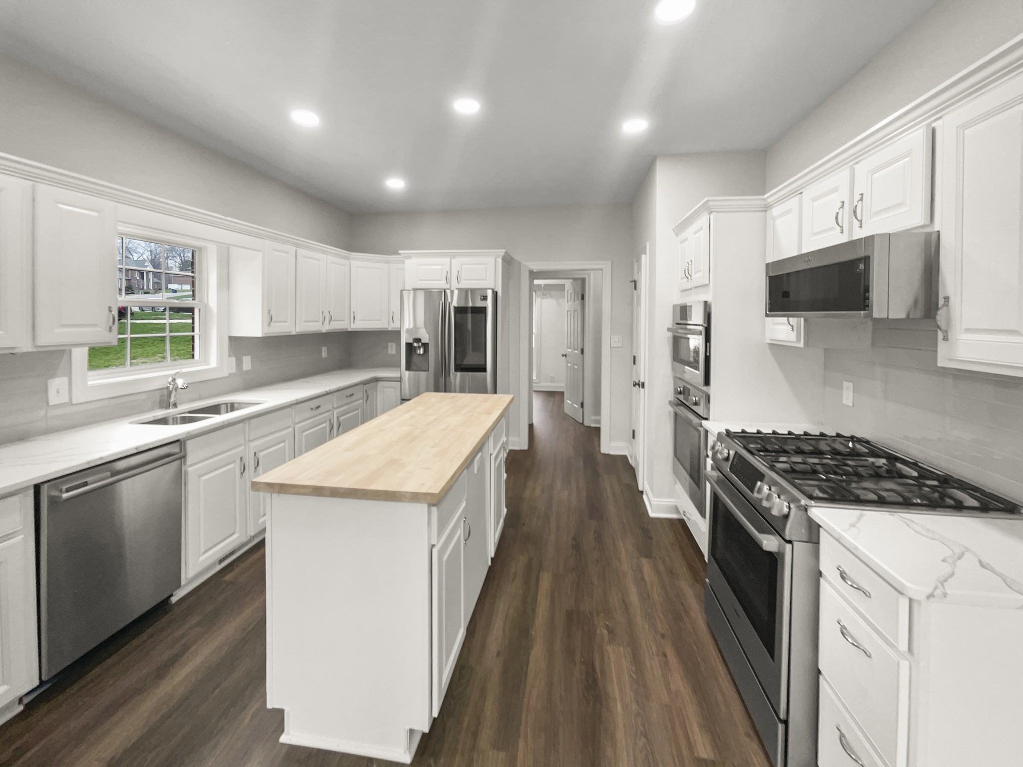 2058 Mossy Oak Circle Clarksville, TN 37043 - Photo 17 of 38 a kitchen with granite countertop a sink a counter top space stainless steel appliances and windows