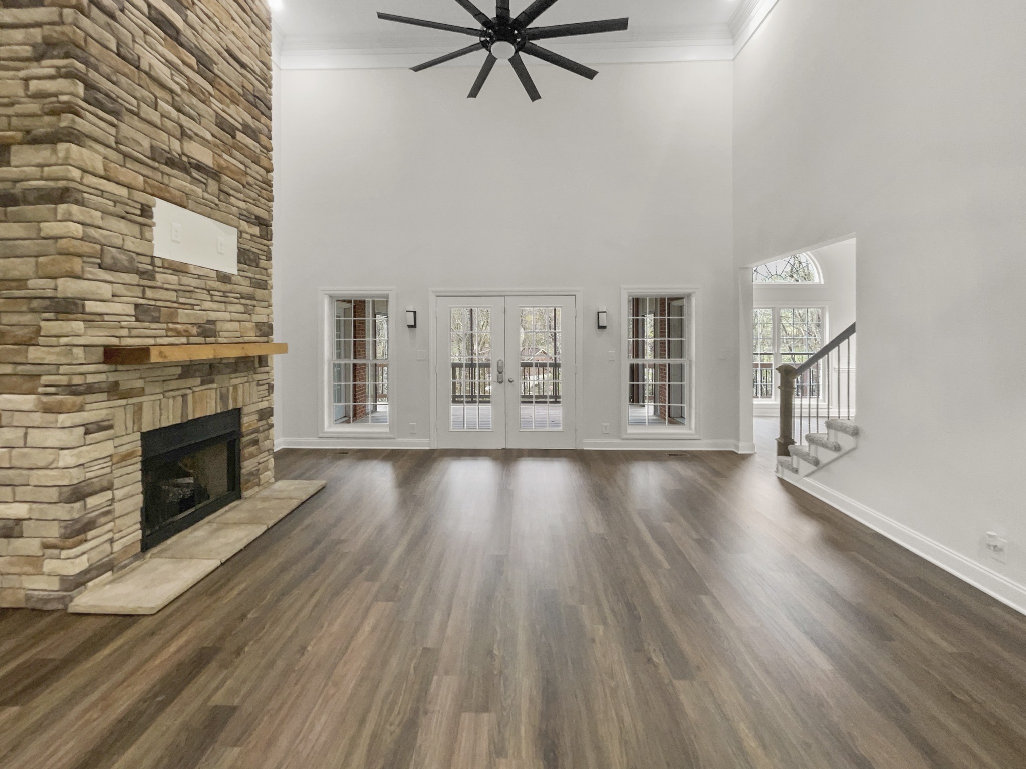 2058 Mossy Oak Circle Clarksville, TN 37043 - Photo 3 of 38 an empty room with wooden floor a fireplace and windows