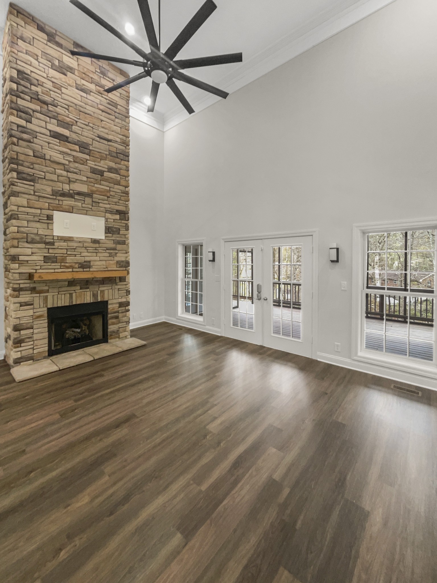 2058 Mossy Oak Circle Clarksville, TN 37043 - Photo 9 of 38 a view of a livingroom with wooden floor a fireplace and windows