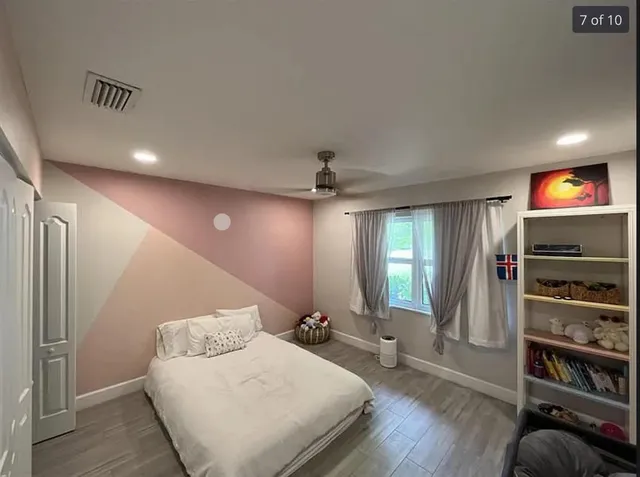 a bed room with a bed and a television