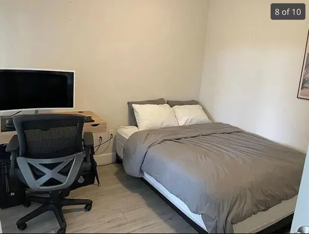 a bedroom with a bed and a chair