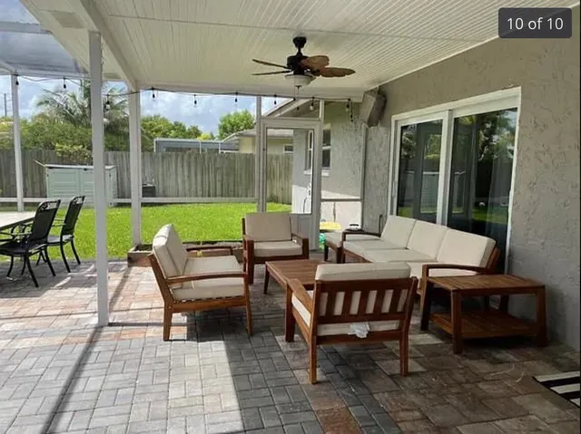 a view of a patio with a dining table and chairs