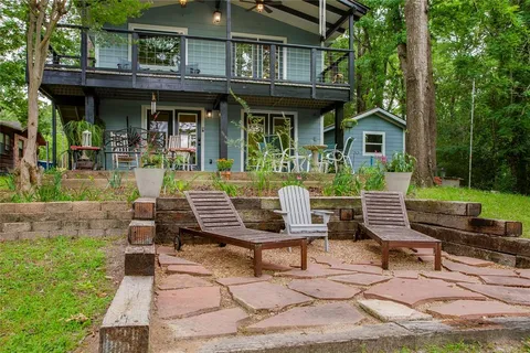 a front view of a house with garden and patio