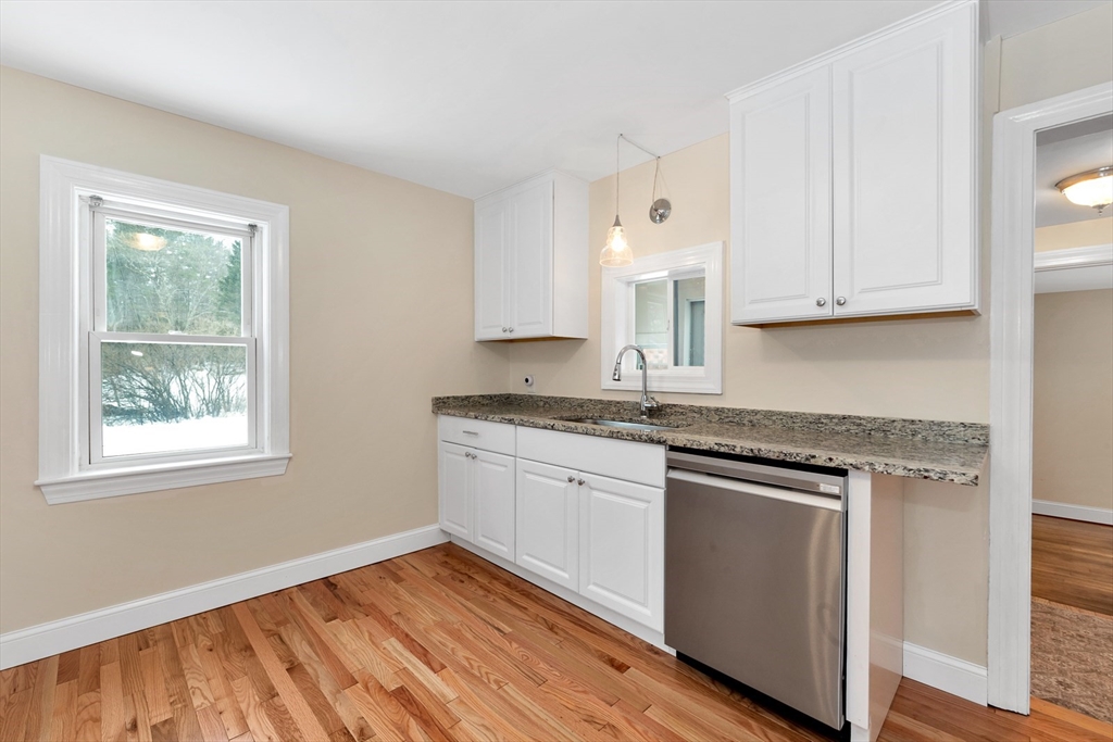92 Squannacook Road Shirley, MA 01464 - Photo 13 of 22 a kitchen with granite countertop wooden cabinets stainless steel appliances a sink and a window