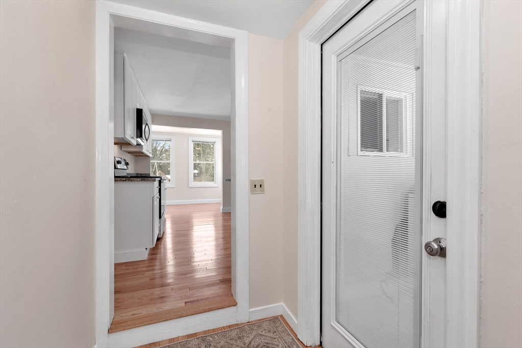 92 Squannacook Road Shirley, MA 01464 - Photo 17 of 22 a view of a hallway with wooden floor and a livingroom