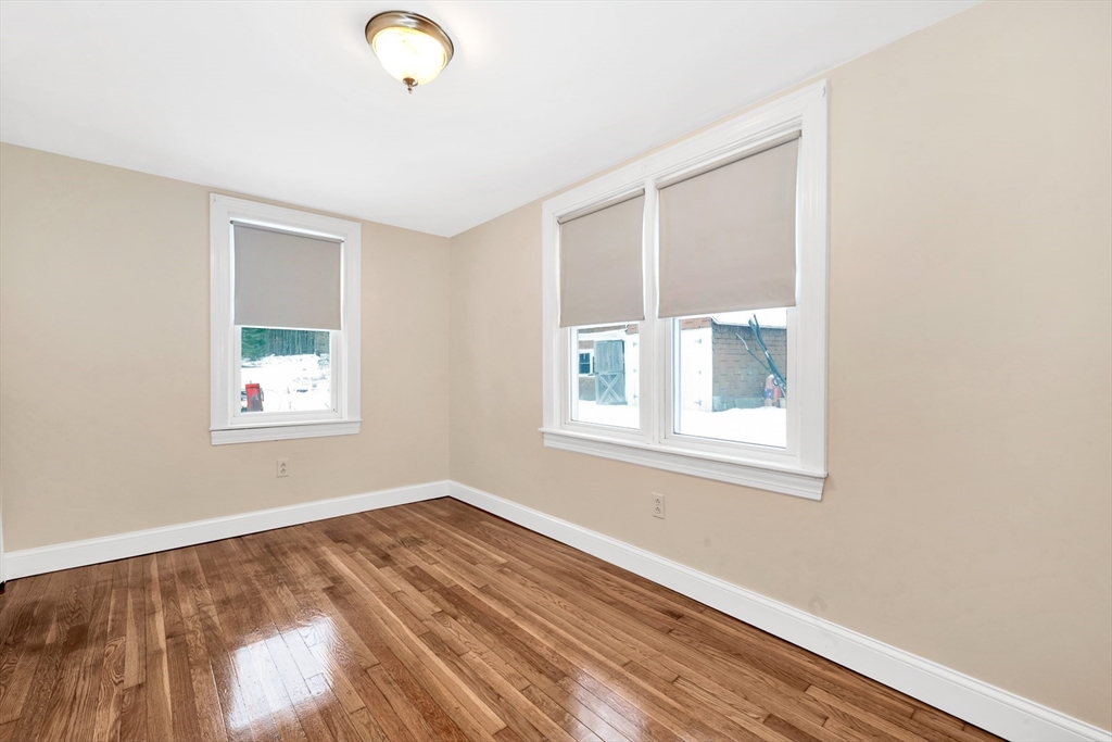 92 Squannacook Road Shirley, MA 01464 - Photo 18 of 22 a view of an empty room with wooden floor and a window