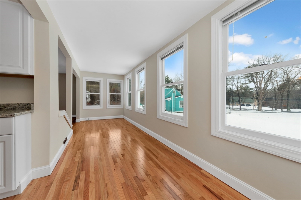 92 Squannacook Road Shirley, MA 01464 - Photo 5 of 22 a view of an empty room with wooden floor and a window