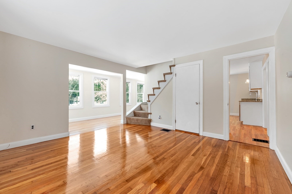 92 Squannacook Road Shirley, MA 01464 - Photo 10 of 22 a view of empty room with wooden floor and stairs