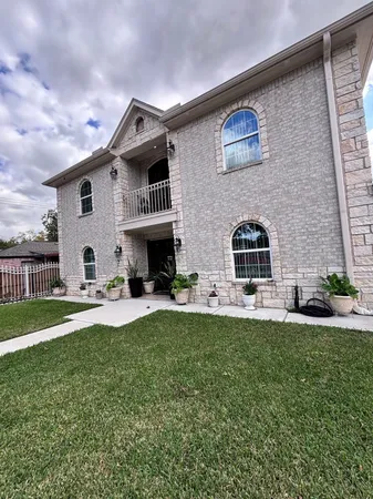 a front view of a house with a garden