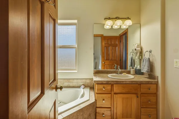 a en suite bathroom with a sink double vanity and a mirror