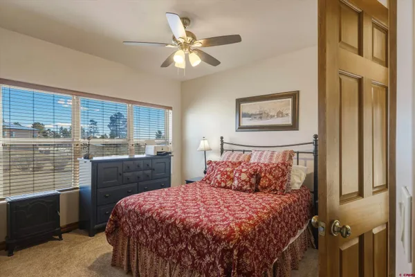 a bedroom with a bed and a lamp