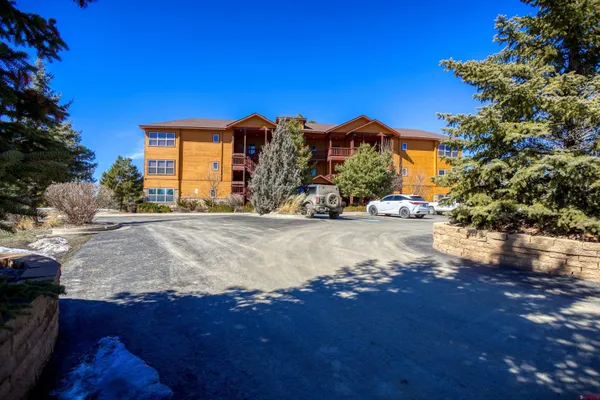 a bedroom with a large bed and a flat tv screen on dresser