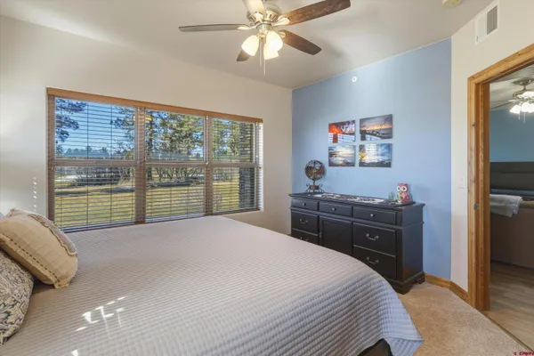 a kitchen with kitchen island granite countertop a sink and refrigerator