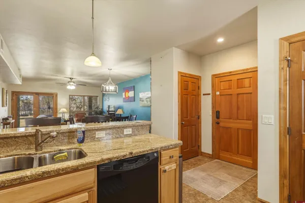 a view of a bedroom with wooden floor and furniture
