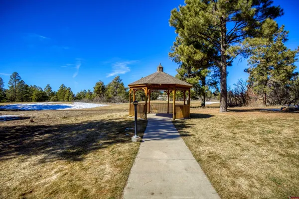 a view of a patio with a table and chairs next to a yard
