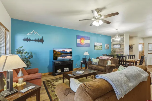 a living room with furniture a chandelier and a dining room