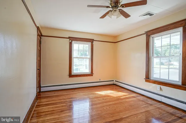 a view of a room with window and wooden floor