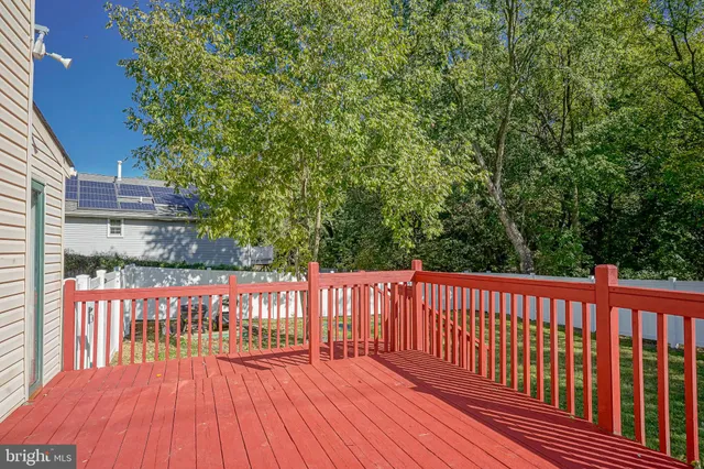 a view of a deck with wooden floor and fence