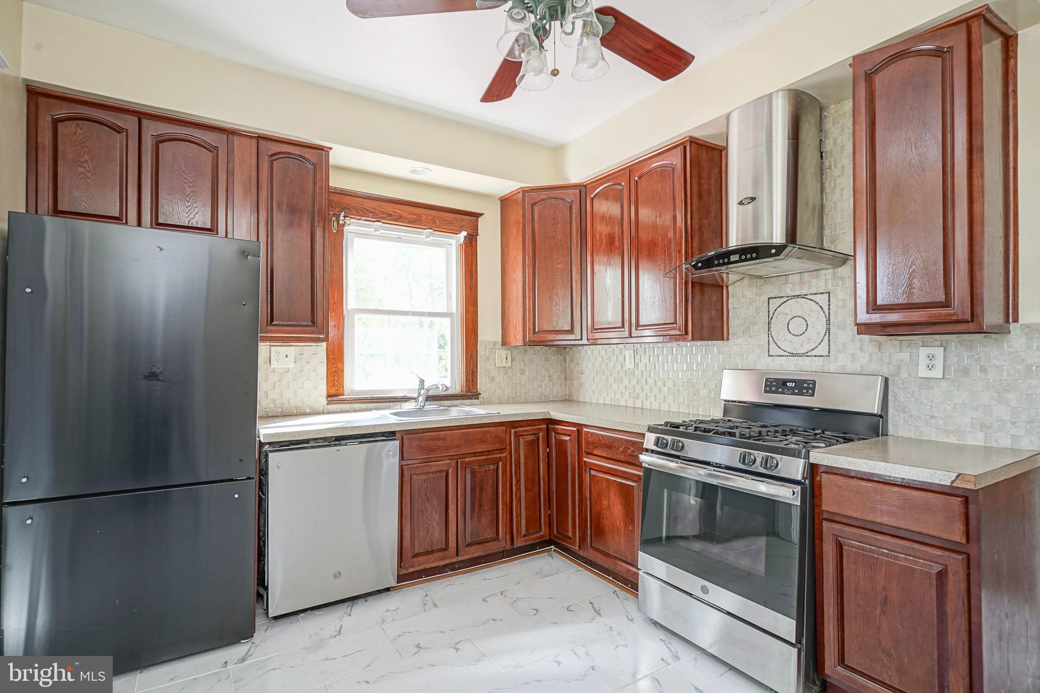 166 East Evesham Road Cherry Hill, NJ 08003 - Photo 8 of 34 a kitchen with stainless steel appliances granite countertop a refrigerator a sink dishwasher a stove and white countertops with cabinets