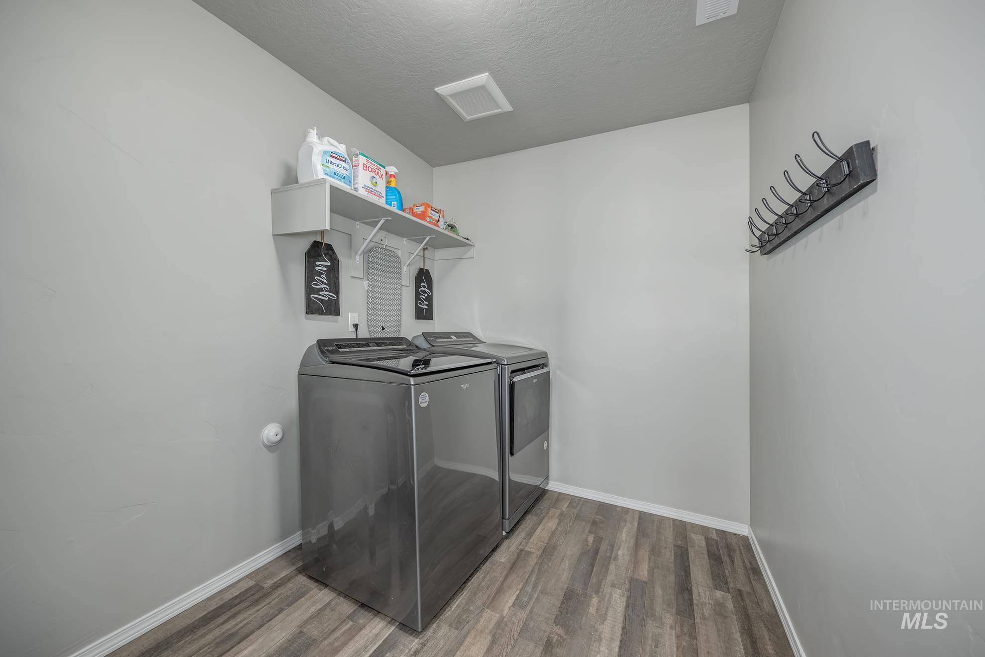 1049 Price Road Weiser, ID 83672 - Photo 25 of 47 Dedicated laundry area featuring wood-finish flooring and light gray walls
