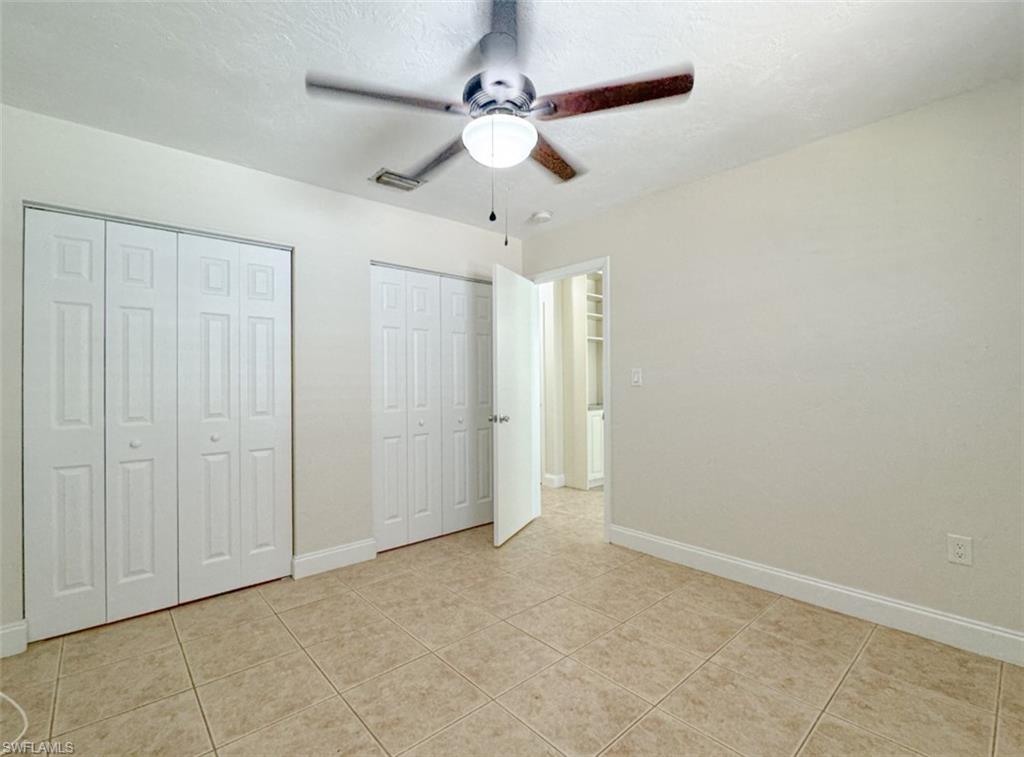 746 109th Avenue North Naples, FL 34108 - Photo 11 of 22 wooden floor in an empty room