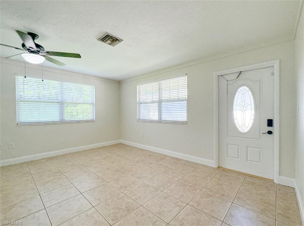 746 109th Avenue North Naples, FL 34108 - Photo 14 of 22 an empty room with windows and fan