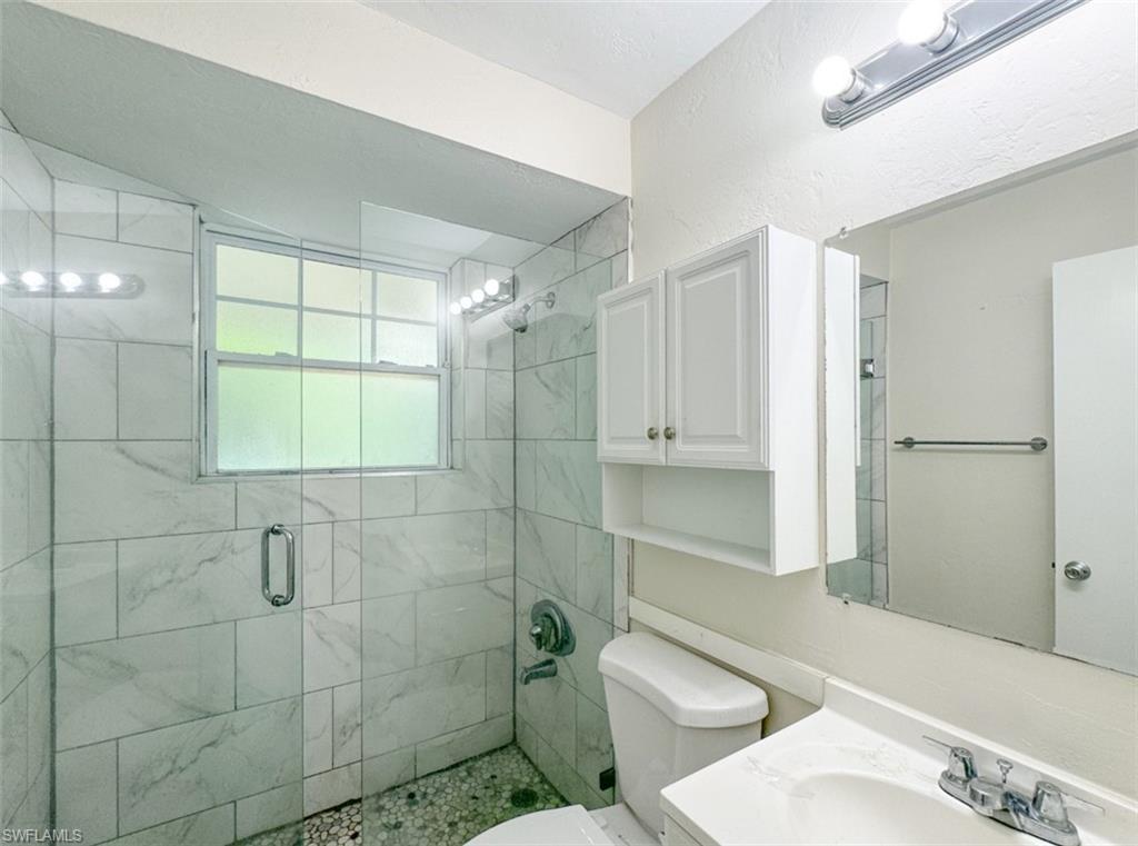746 109th Avenue North Naples, FL 34108 - Photo 15 of 22 a bathroom with a sink a toilet and shower