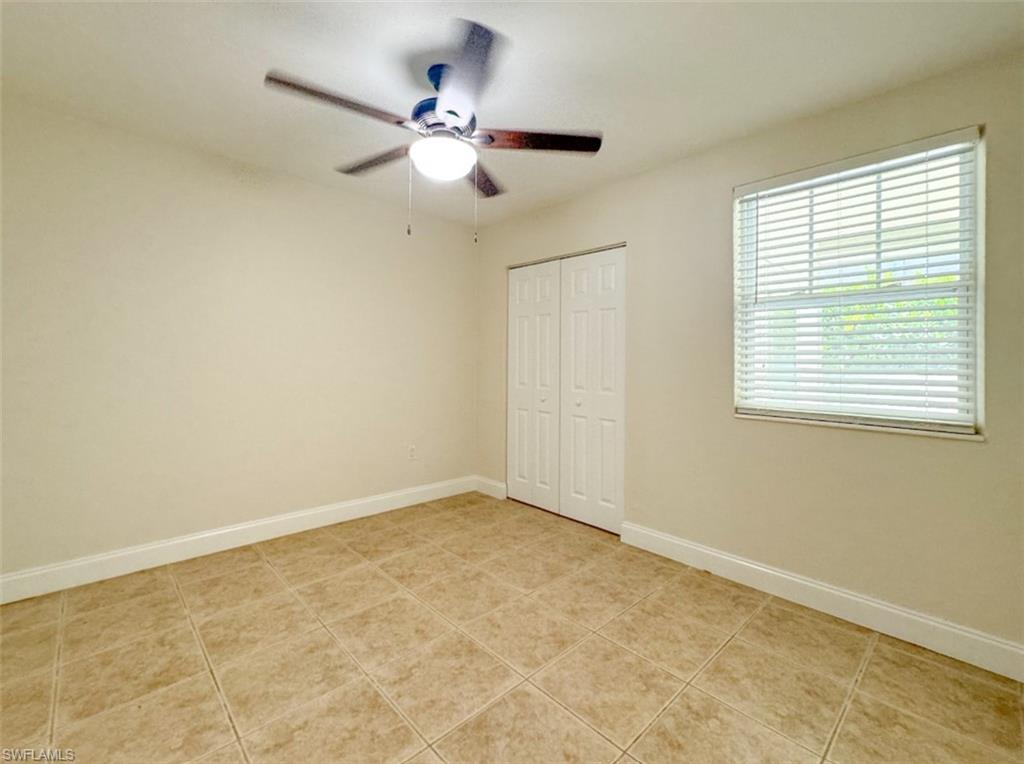 746 109th Avenue North Naples, FL 34108 - Photo 16 of 22 an empty room with a window and a fan
