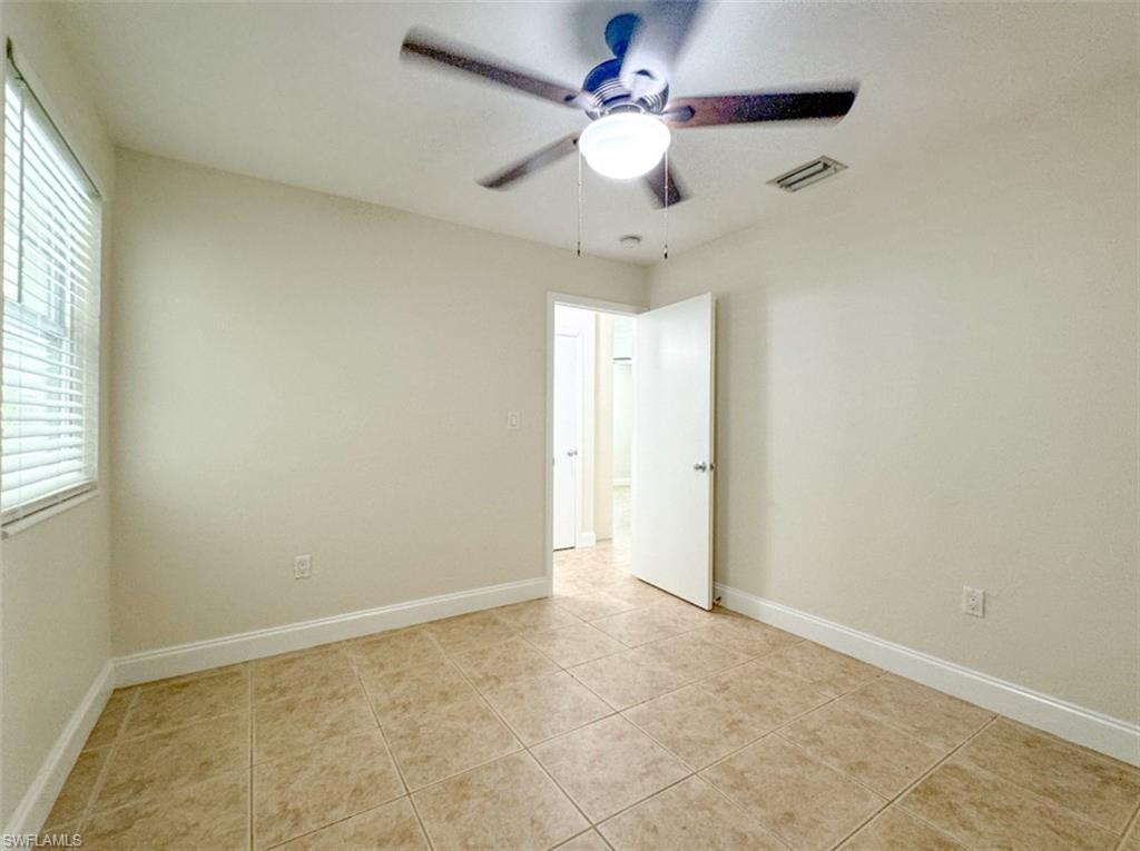 746 109th Avenue North Naples, FL 34108 - Photo 18 of 22 an empty room with a window and a fan