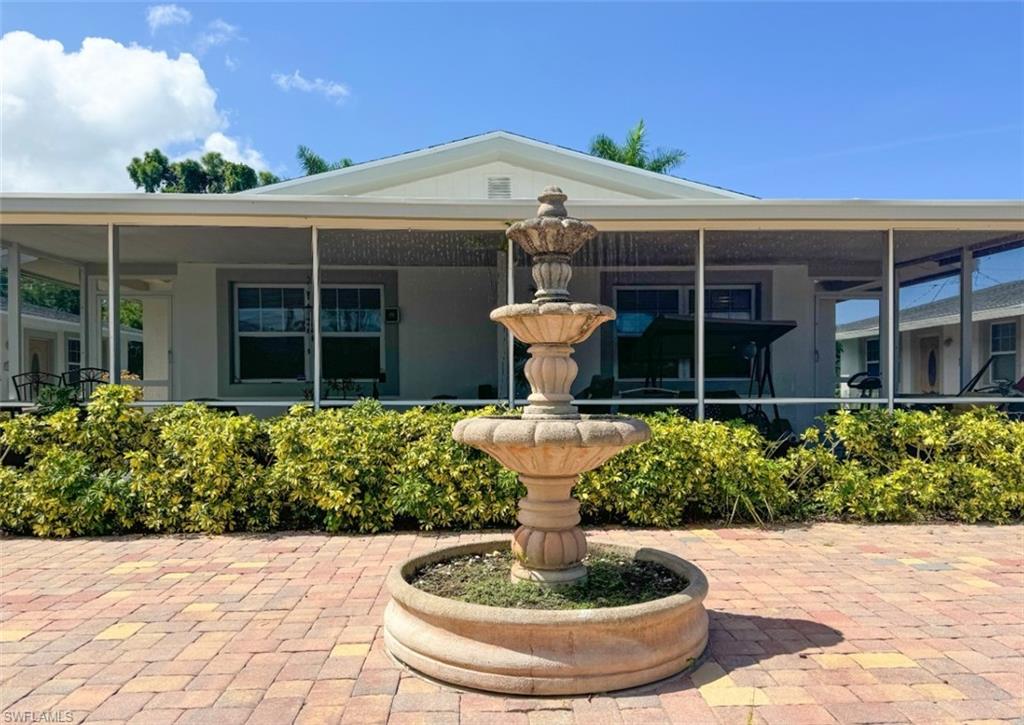 746 109th Avenue North Naples, FL 34108 - Photo 20 of 22 a front view of a house with a fountain
