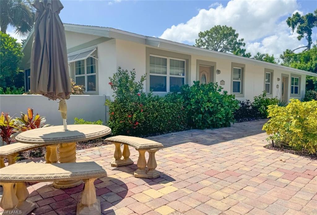 746 109th Avenue North Naples, FL 34108 - Photo 21 of 22 a view of a patio with table and chairs potted plants