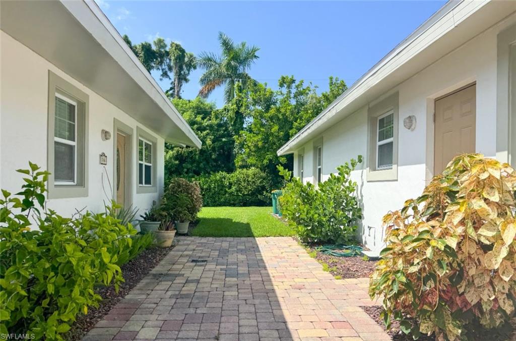 746 109th Avenue North Naples, FL 34108 - Photo 22 of 22 a front view of a house with garden