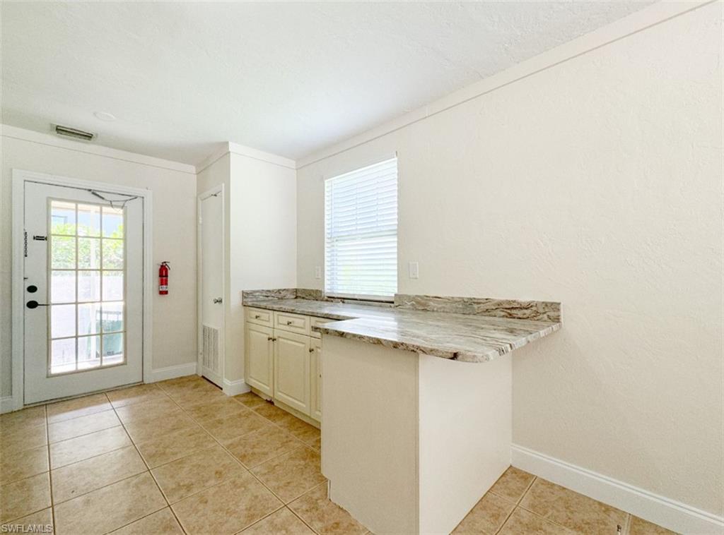 746 109th Avenue North Naples, FL 34108 - Photo 6 of 22 a view of a kitchen with a sink and dishwasher next to a window
