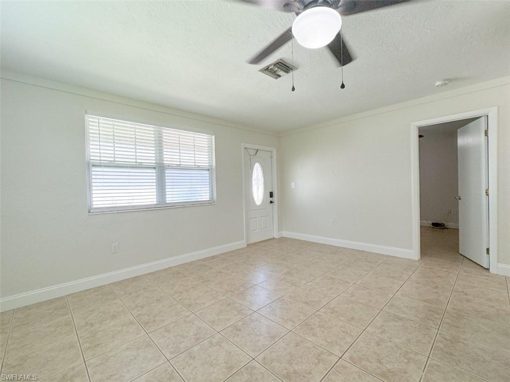 746 109th Avenue North Naples, FL 34108 - Photo 7 of 22 wooden floor in an empty room with a window