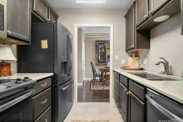 a kitchen with a sink appliances and cabinets