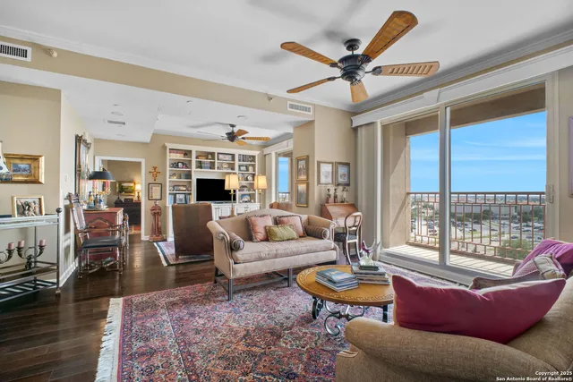 a living room with furniture a fireplace and a large window
