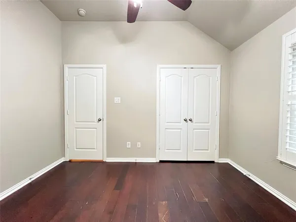 an empty room with wooden floor