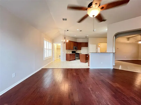a view of a kitchen with a dishwasher cabinets and wooden floor