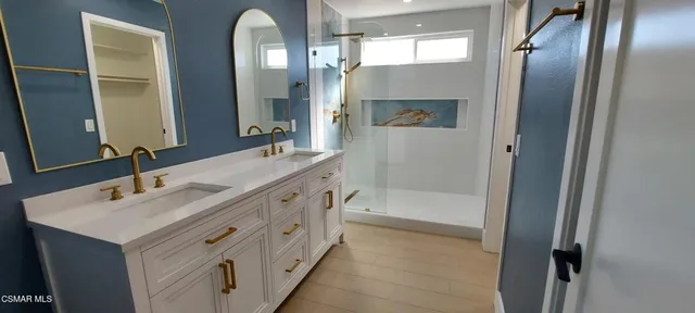 a bathroom with a double vanity sink and a mirror