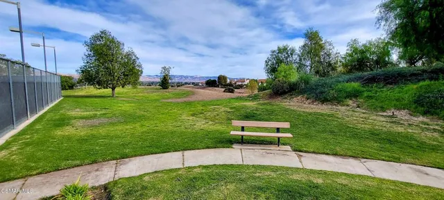 a view of a backyard with a garden and entertaining space