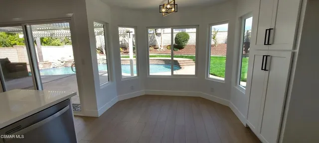a view of hallway with furniture and a floor to ceiling window